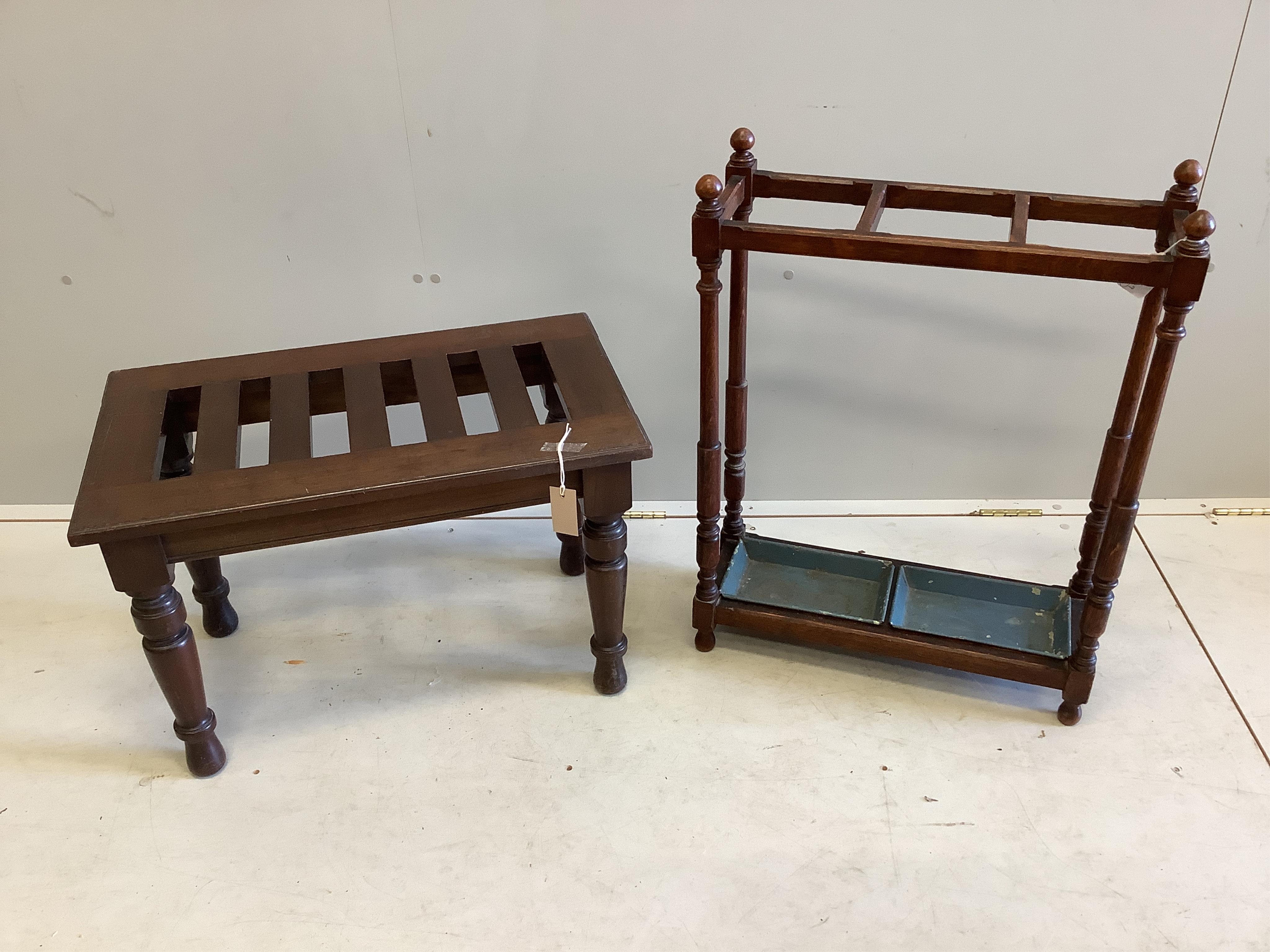 A late Victorian mahogany luggage stand on turned supports, width 69cm, depth 40cm, height 46cm and an early 20th century oak three division umbrella stand